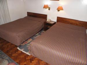 Voodi või voodid majutusasutuse Vajra Hotel toas