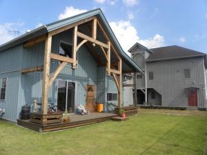 a large barn with a porch and a house at B&BHOUSE FAM - Vacation STAY 39468v in Ichinomiya