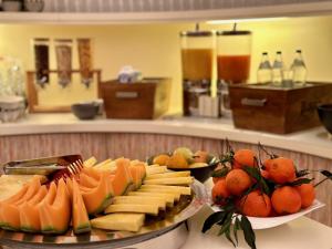 une assiette de fromage et de fruits sur un comptoir dans l'établissement Casinohotel Velden, à Velden am Wörther See