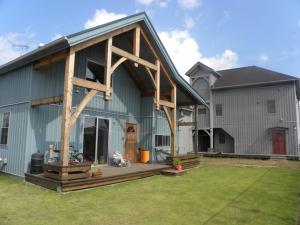 a large blue barn with a porch on it at B&BHOUSE FAM - Vacation STAY 39533v in Ichinomiya