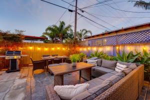 un patio con sofá, mesa y parrilla en Pacific Paradise - Large Patio, Hot Tub, Short Walk to Beach, & Parking, en San Diego