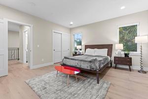 a bedroom with a bed and a red stool at The Garden House--5 bedrooms, sleeps 12 in San Jose