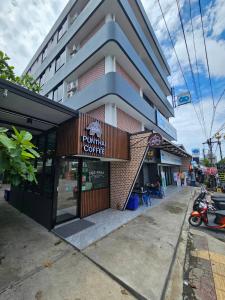 a building with a sign that reads pumpkin coffee at Irich Residence สาขา สำโรงใต้ in Samut Prakan