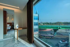 a hotel room with a view of a city at Hotel Vilvah in Coimbatore