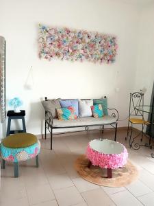 a living room with a couch and two tables at Studio meublé Yaoundé Ekounou in Yaoundé