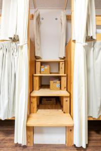 a closet with wooden shelves and curtains at Almas Guest House(アルマス） in Nagasaki