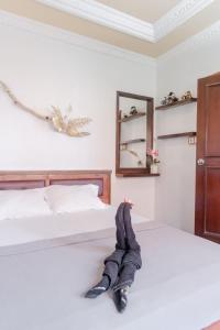 a pair of beds in a bedroom with a stuffed animal at Pigeon Mandala Apartments & Resto in Nusa Dua