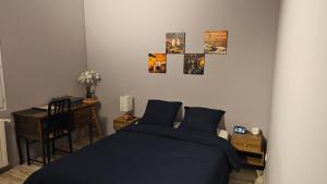 a bedroom with a bed and a desk and some pictures at Bed To Rent - Maison Calme avec Jacuzzi sous Supplément in Bordeaux