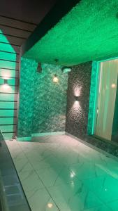 a room with a stone wall with green lights at Luxury 4 Bhk Villa Homestays in Patiāla
