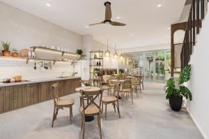 a dining room with tables and chairs in a restaurant at Hoi An Pinus Boutique in Tân Thành (1)