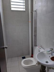 a bathroom with a toilet and a sink at Homestay Taman Kota Emas 