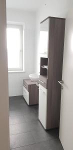 a bathroom with a sink and a toilet and a mirror at Top Appartement für Business-Wohnen-Urlaub in Wiener Neustadt