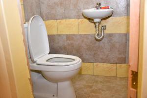 a bathroom with a toilet and a sink at Muthiga Garden Resort Chaka in Nyeri +34 photos