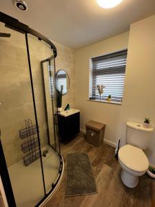 a bathroom with a toilet and a glass shower at Salt View in Cullen