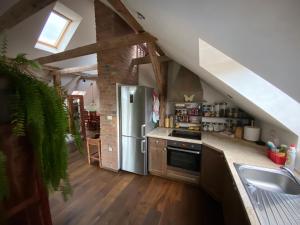 a kitchen with a stainless steel refrigerator in an attic at Stunning Hills View Apartment Vransko in Vransko