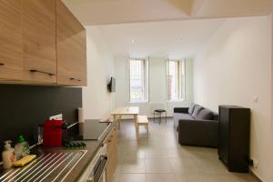a kitchen and living room with a couch and a table at FLC-PANIER- OLD PORT 500m - T3- 2 Bedrooms -Maxi 6 Guests in Marseille