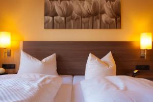 Postel nebo postele na pokoji v ubytování Hotel Thüringer Hof