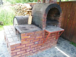 an outdoor brick oven sitting on a patio at Pensiunea Casa Filoxenia in Horezu +51 photos