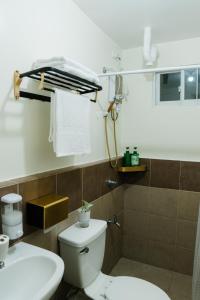 a bathroom with a toilet and a sink at Peaceful & quiet 1BR condo w/ pool access, TV&Wifi in Davao City