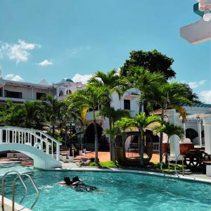 two people in the swimming pool at a resort at Villa Apolonia Resort in San Juan