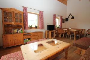 a living room with a wooden table and a dining room at Schwoicherbauer in Wörgl