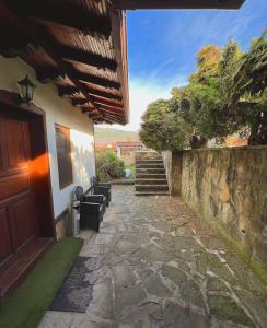 a stone walkway leading to a house with a stone wall at Complex Ristanite in Elena