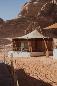 a tent in the desert next to a mountain at Valley Resort in Wadi Rum