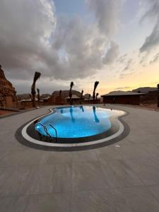 a swimming pool with people in the middle of it at Valley Resort in Wadi Rum