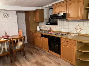 a kitchen with wooden cabinets and a stove top oven at Schönes Ferienhaus in Braubach in Braubach