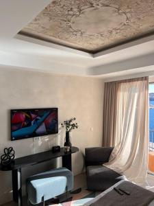 un soggiorno con divano, tavolo e soffitto di Kratísti a Ermoupoli