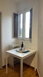 una mesa blanca en una habitación con 2 ventanas en Apartamento acogedor en La Molina, 2hab, Wi Fi, en La Molina