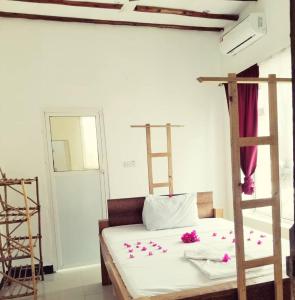 a bedroom with a bunk bed with pink flowers on it at Room in BB - Room Viv glaund flow with 2 guests in Nungwi