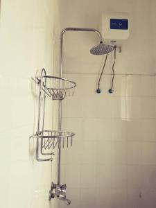 a bathroom with a shower with three baskets on the wall at Room in BB - Room Viv glaund flow with 2 guests in Nungwi