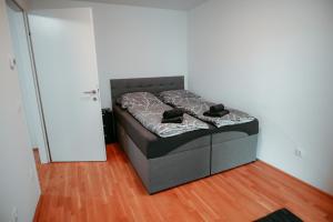 a bed in the corner of a room at Vienna Cozy Apartment 105 in Vienna