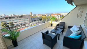 a balcony with two chairs and a table at Sea Vibes in Burgas City