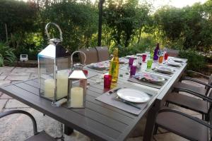 a picnic table with candles and a table set for a meal at Maison de charme en Bourgogne in Coulanges-lès-Nevers