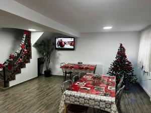 a dining room with a christmas tree and a dining table at Casa Lidia in Rîu de Mori