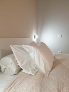Uma cama ou camas num quarto em Piccolo Hotel Olina