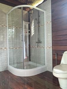 a glass shower in a bathroom with a toilet at Kohjum Freedom Resort in Ko Jum