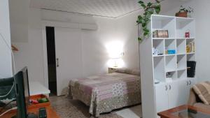 a bedroom with a bed and a desk with a lamp at A casa do Santo in Pontevedra