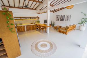a living room with a table and a dining room at Palm Merah Villas - Private pool in Selong Belanak