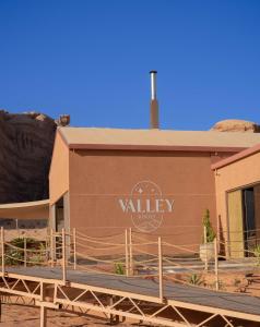 a building with a sign on the side of it at Valley Resort in Wadi Rum