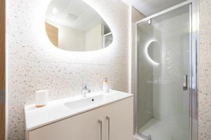 a bathroom with a sink and a mirror at Les Petits Pavillons Standing Clim Vieux-Port - MaisonMars in Marseille