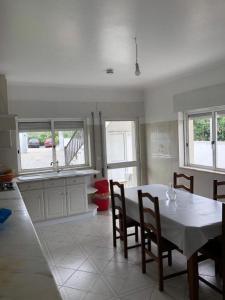 a kitchen with a table and chairs in a room at Villa Abreu in Esposende