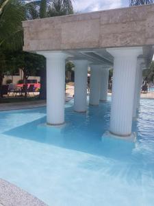 a row of columns on top of a swimming pool at Proprietária in Caldas Novas