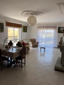 a living room with a table and a couch at Villa Abreu in Esposende