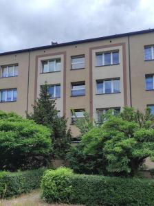 a large building with trees in front of it at ***Santorini Apartament*** - 40m² ✓ in Rybnik