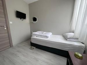 a small bedroom with a bed and a window at HOTEL KOCABASOGLU in Istanbul