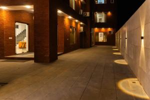 an empty hallway of a building at night at Sandane Homes By The Lodgers Near India Expo Centre & Mart Greater Noida in Greater Noida