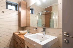 a bathroom with a sink and a mirror at Ταξιδιώτες Travellers in Megalópolis +24 photos